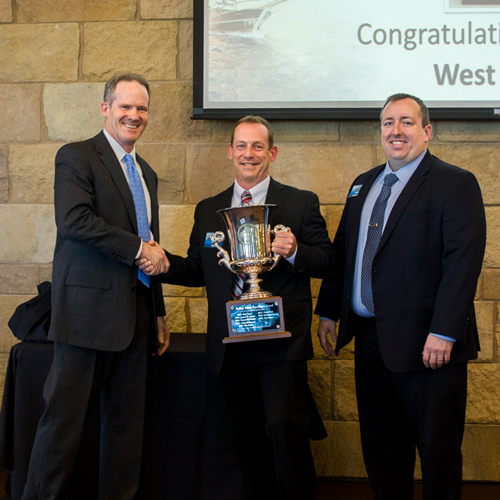 Image of the most recent Chairman’s Cup Award Winner standing with NuStar’s CEO Brad Barron.
