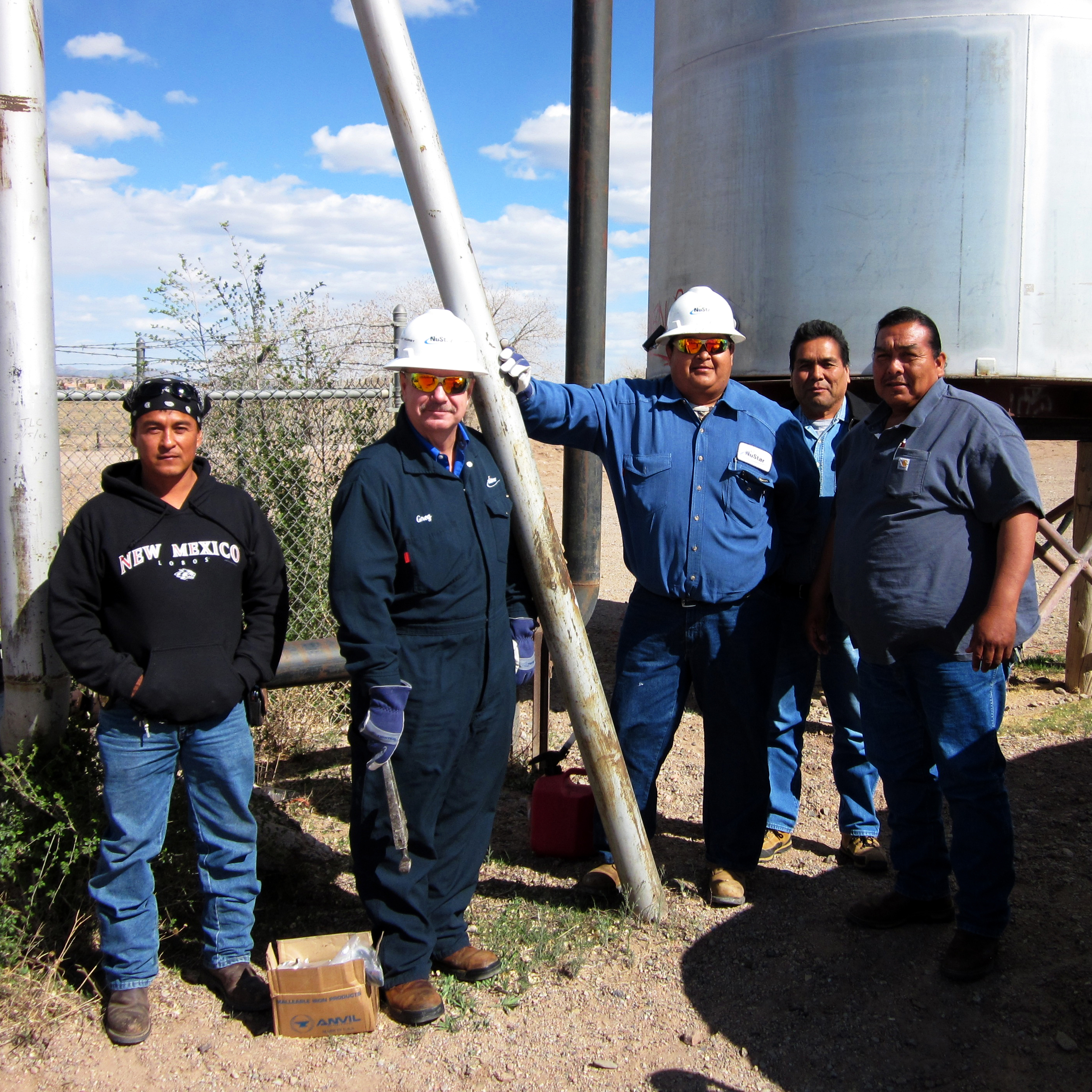 Image of members of indigenous community and NuStar employees working together 